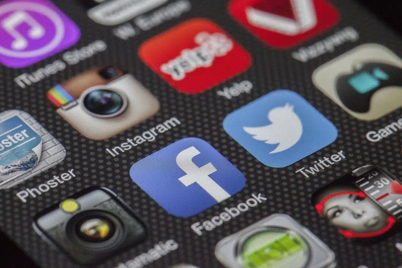 Facebook advertising for small businesses and startups shown with social media app icons on a smartphone screen