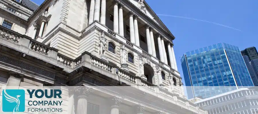 Historic bank building with columns beside modern glass office, illustrating UK Business Bank Account for Non-Resident International Client