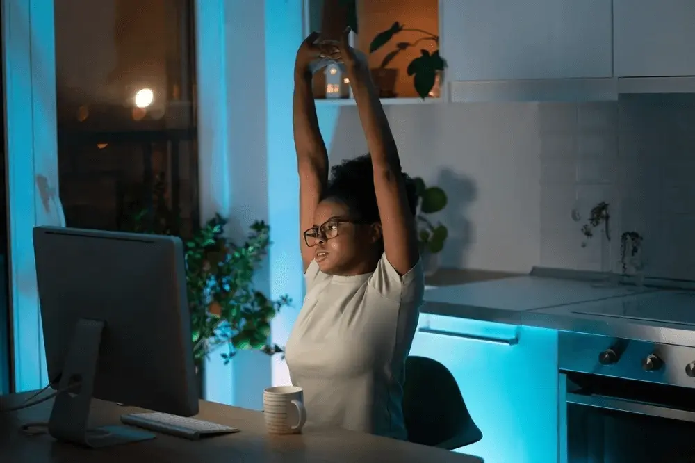 A woman celebrating at her home computer after finding out how long it takes to open a new company in the UK
