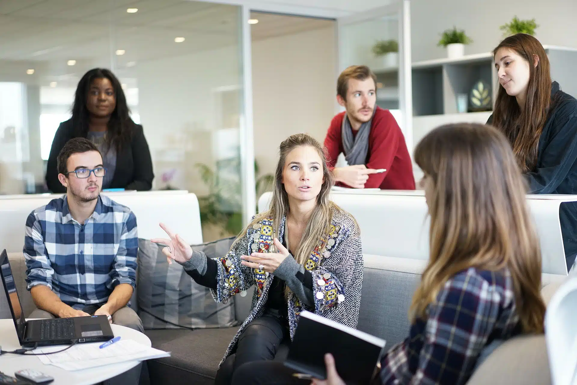 Group of six professionals discussing in an office meeting for Removing a Shareholder from a Limited Company article
