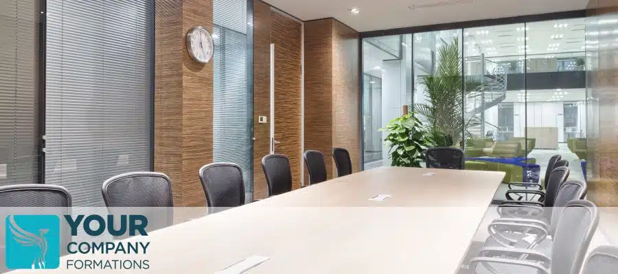 Modern office meeting room with table, chairs, clock and glass walls for Service Address and Registered Office Address article