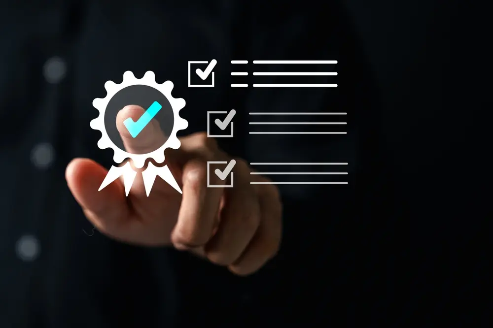 Hand pointing to a certification badge with compliance checklist, representing a UK Authorised Corporate Service Provider